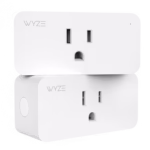 Wyze Plug in an outlet with a lamp turned on, demonstrating the Vacation Mode feature in the app.